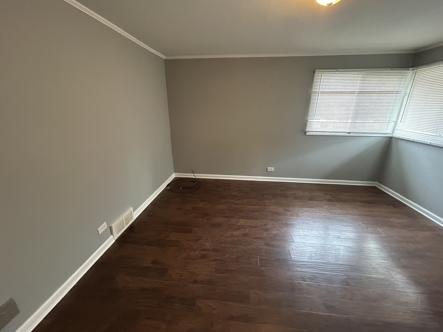 3124 173rd Street Hazel Crest, IL 60429 - Photo 13 of 18 an empty room with wooden floor and windows