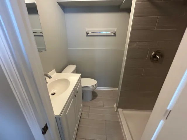 a white toilet sitting next to a sink
