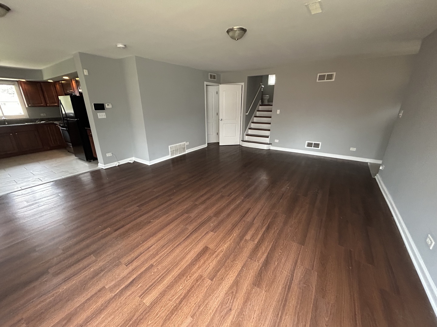 3124 173rd Street Hazel Crest, IL 60429 - Photo 2 of 18 an empty room with wooden floor and windows