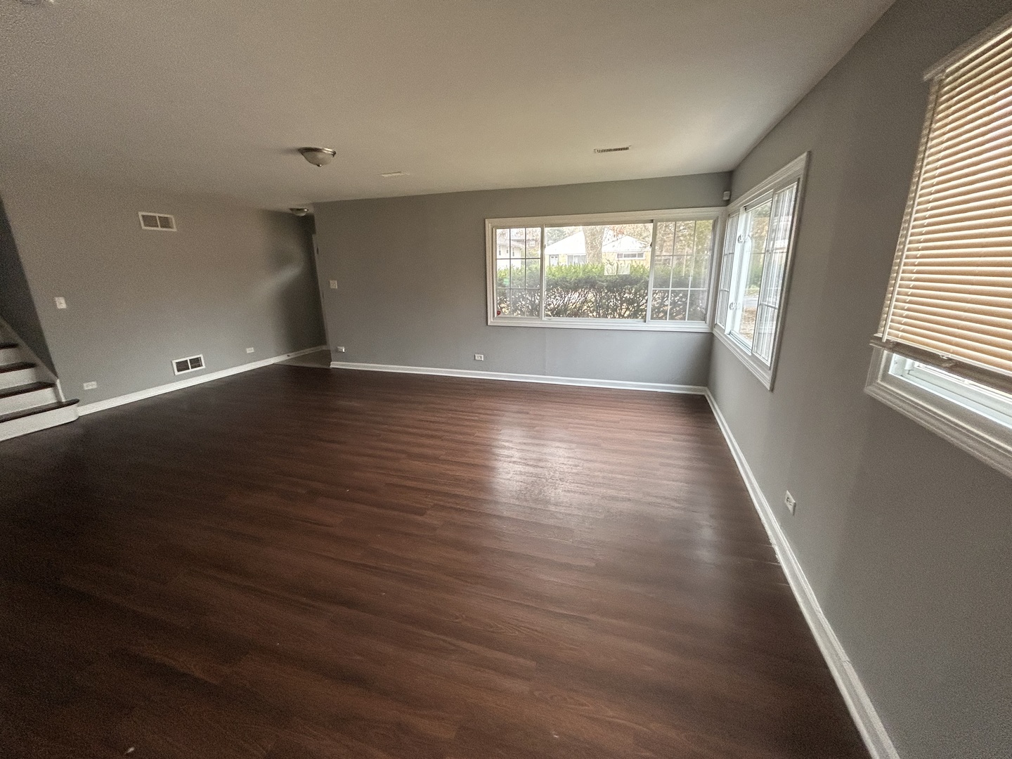3124 173rd Street Hazel Crest, IL 60429 - Photo 3 of 18 an empty room with wooden floor and windows