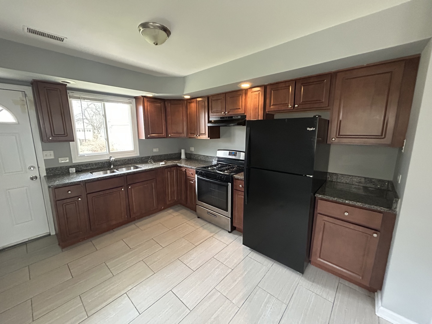 3124 173rd Street Hazel Crest, IL 60429 - Photo 4 of 18 a kitchen with granite countertop stainless steel appliances and cabinets