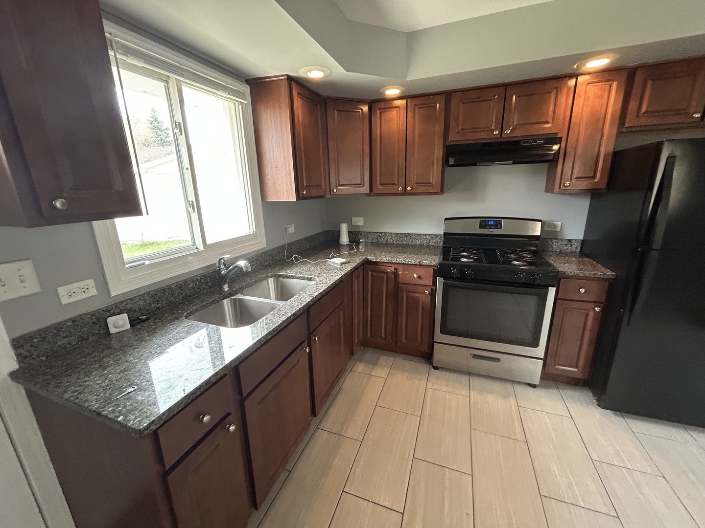 3124 173rd Street Hazel Crest, IL 60429 - Photo 5 of 18 a kitchen with stainless steel appliances granite countertop a sink stove and cabinets