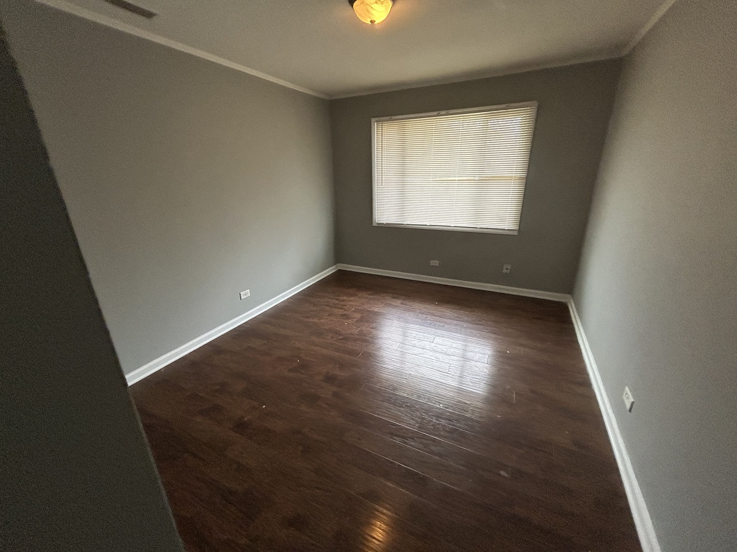 3124 173rd Street Hazel Crest, IL 60429 - Photo 6 of 18 an empty room with wooden floor and windows