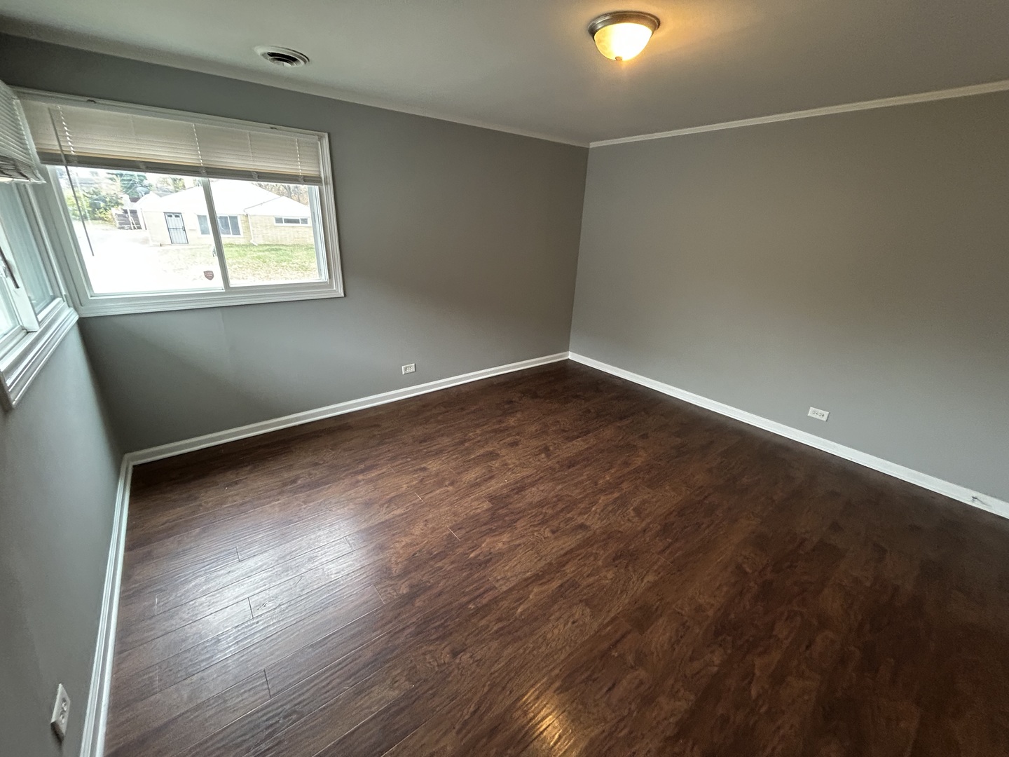 3124 173rd Street Hazel Crest, IL 60429 - Photo 7 of 18 an empty room with wooden floor and windows