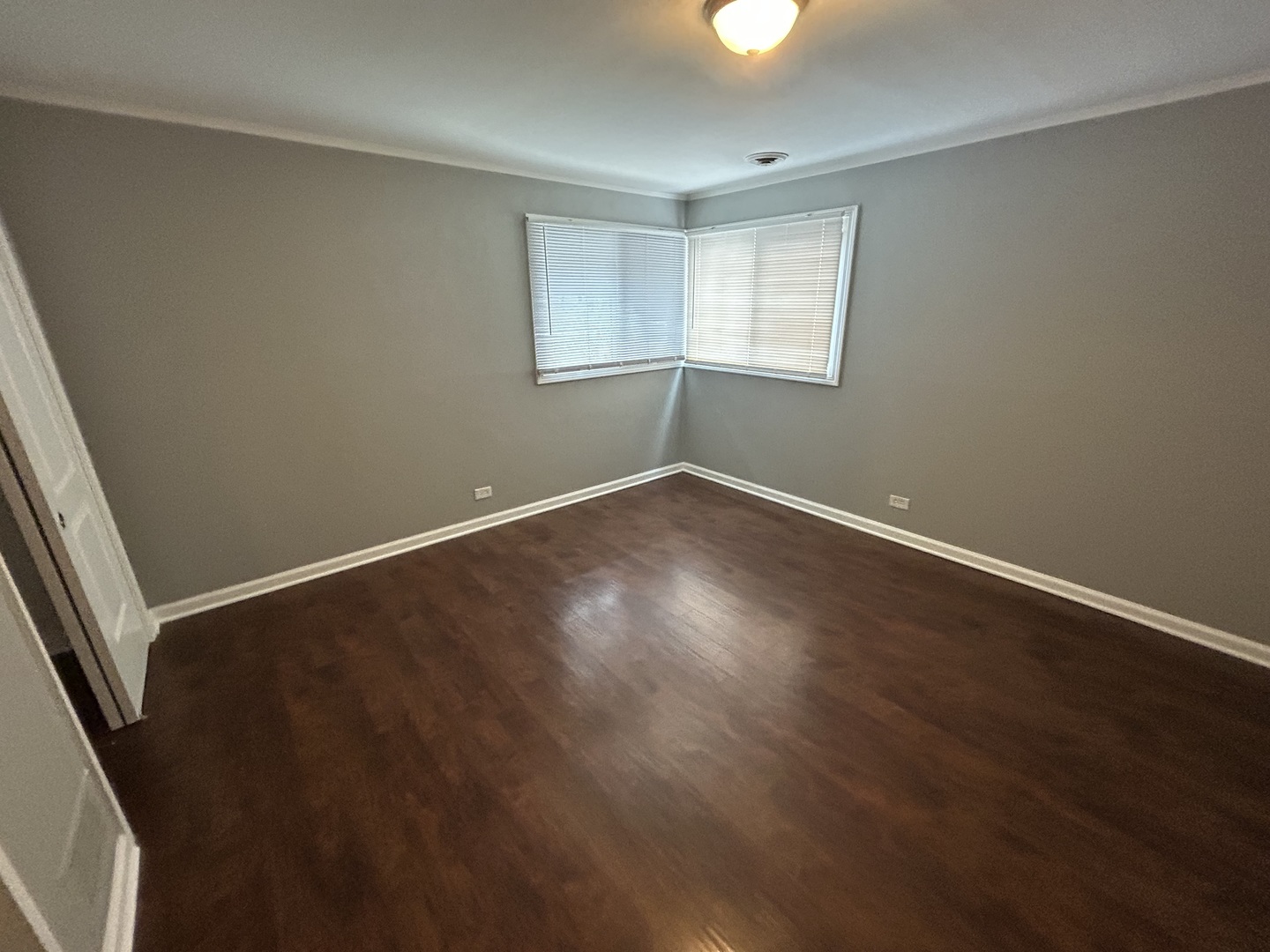 3124 173rd Street Hazel Crest, IL 60429 - Photo 9 of 18 an empty room with wooden floor and windows