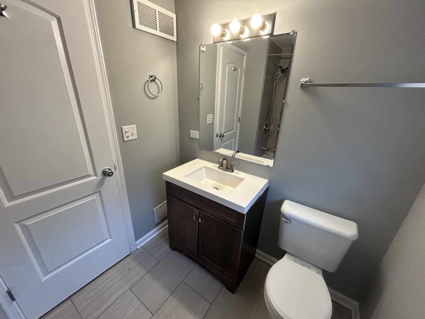 3124 173rd Street Hazel Crest, IL 60429 - Photo 10 of 18 a bathroom with a toilet sink and mirror