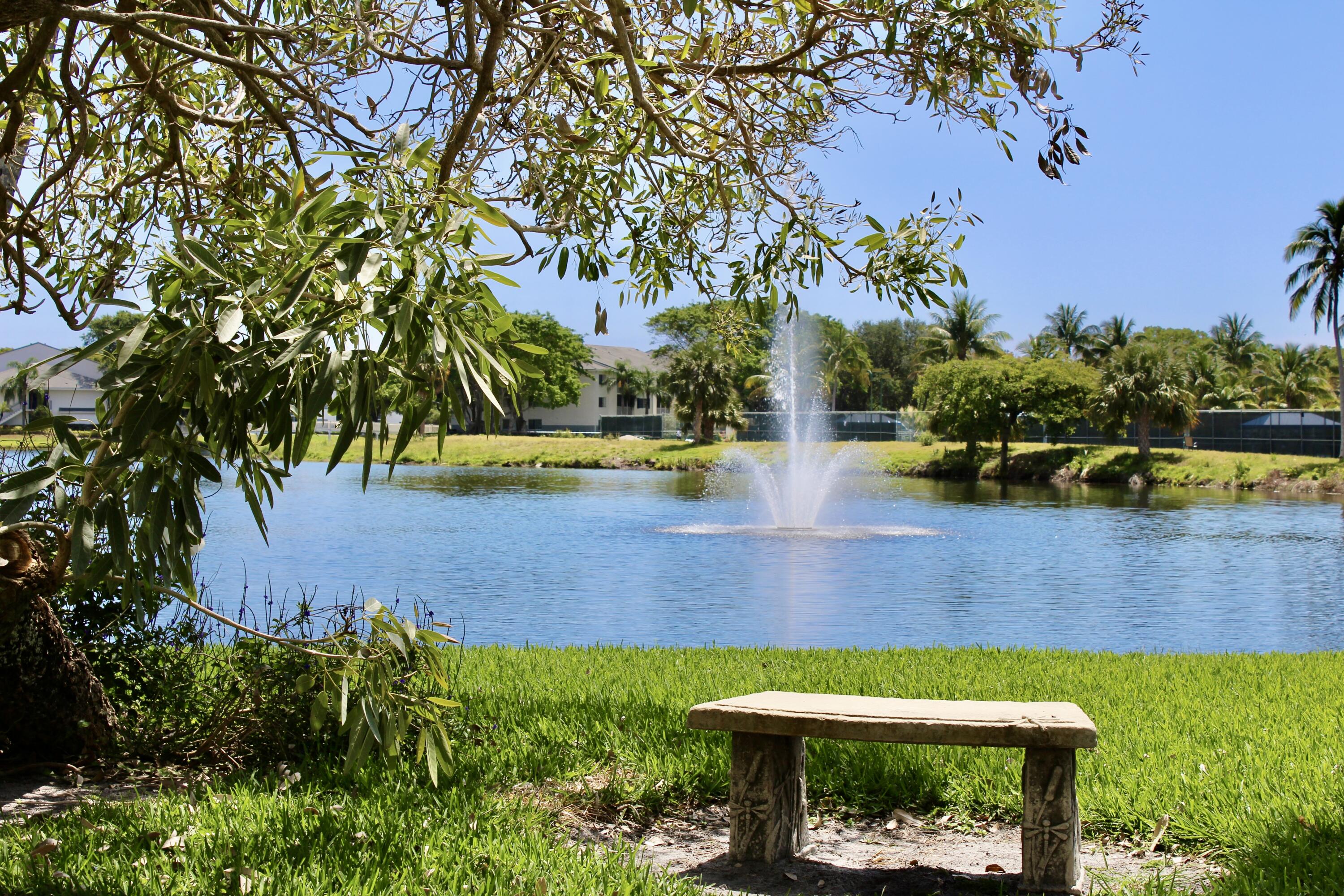 1915 Lavers Circle, Unit E209 Delray Beach, FL 33444 - Photo 3 of 20 a view of a yard with plants and large trees