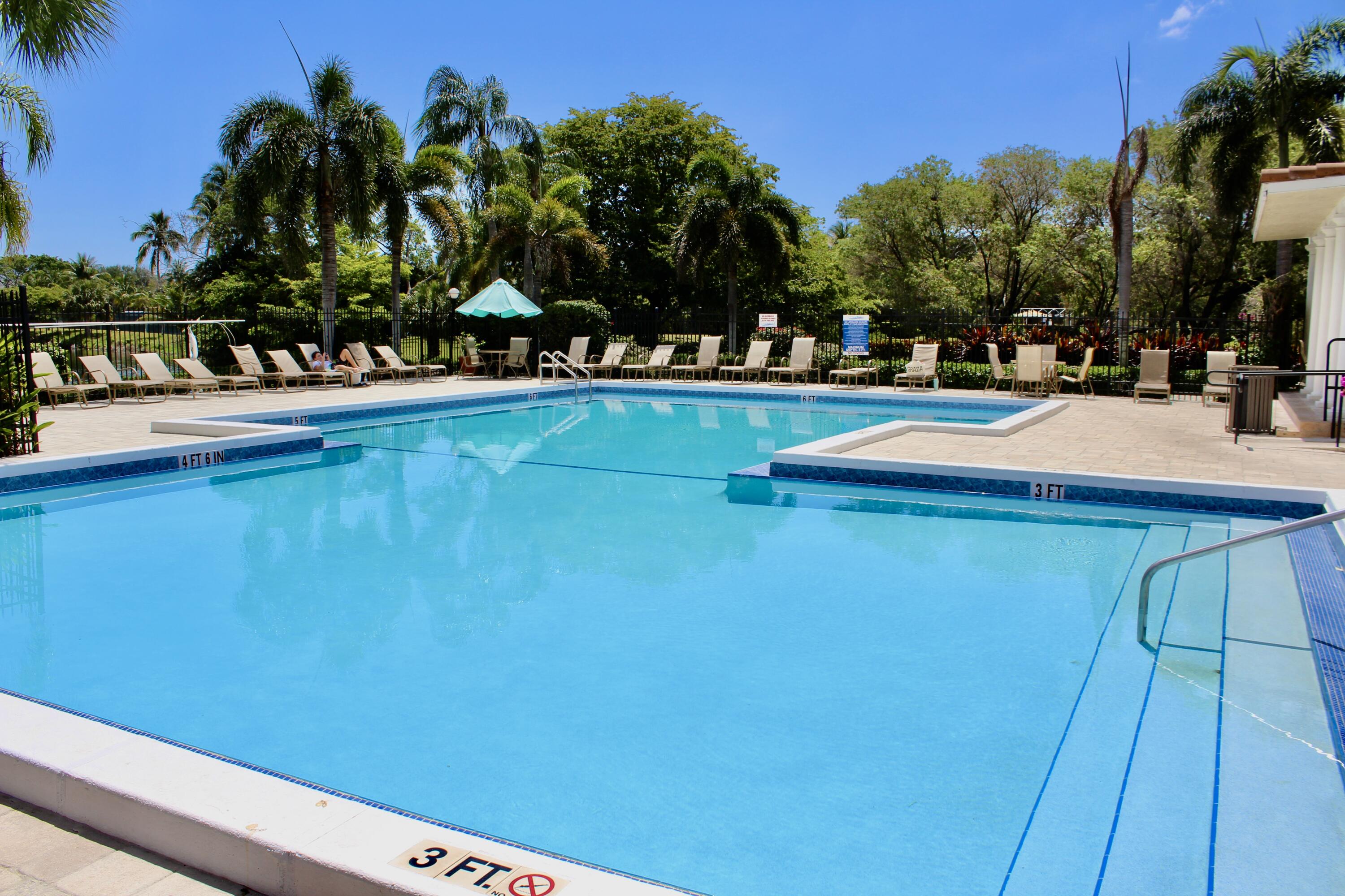 1915 Lavers Circle, Unit E209 Delray Beach, FL 33444 - Photo 4 of 20 a view of swimming pool with outdoor seating and deck