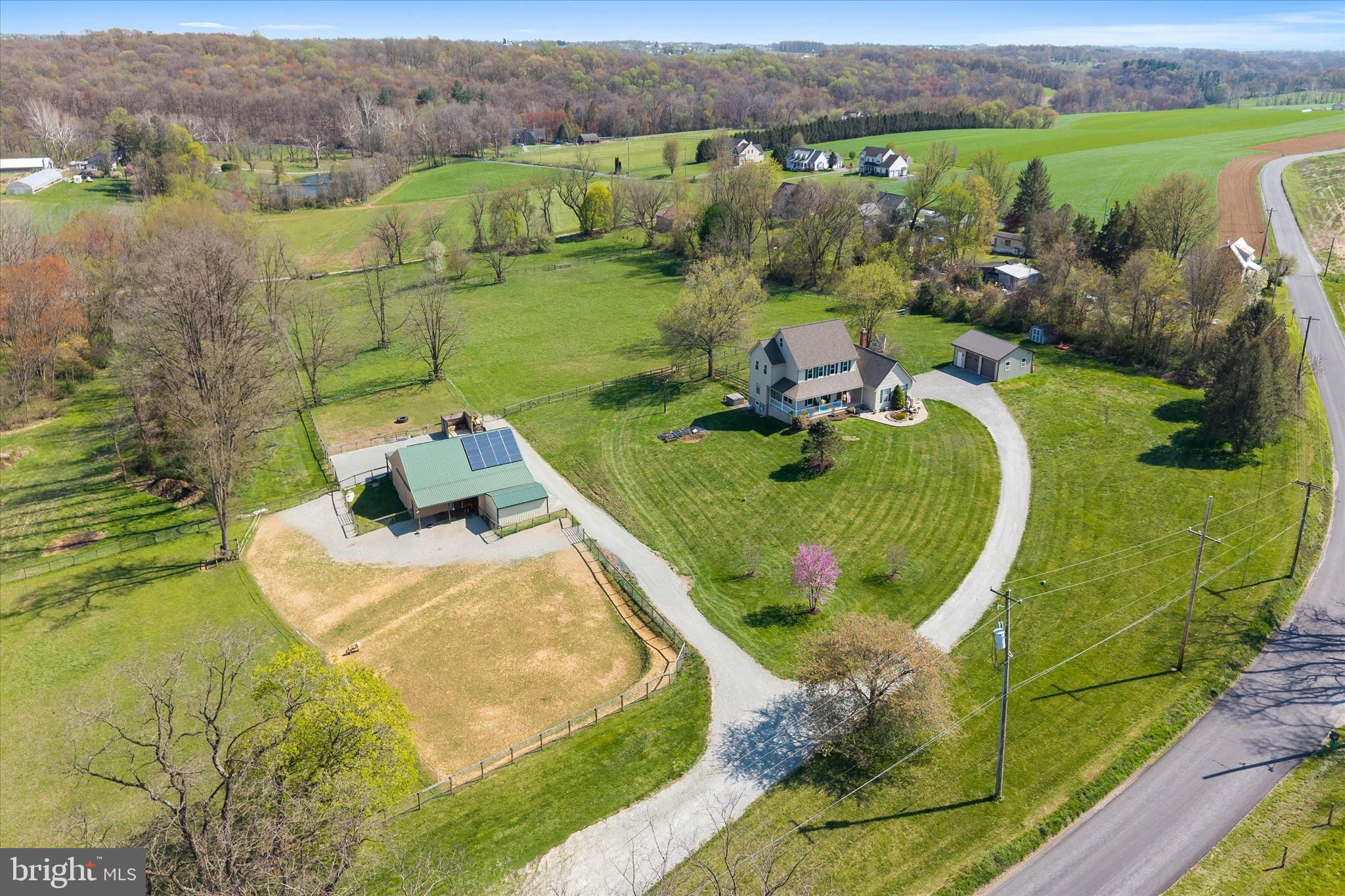 an aerial view of a house with yard swimming pool and outdoor seating