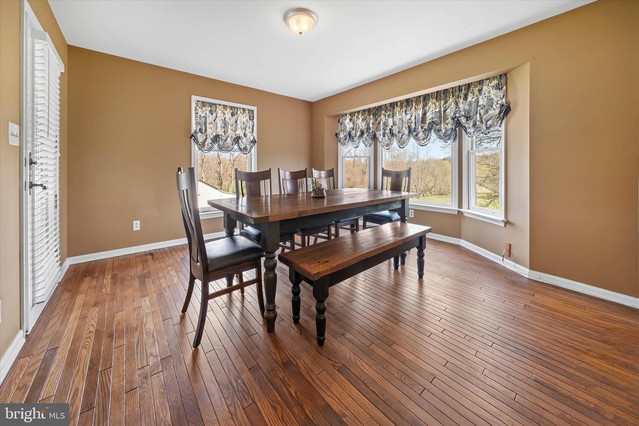 4012 Homeville Road Cochranville, PA 19330 - Photo 15 of 57 a view of a dining room with furniture window and wooden floor