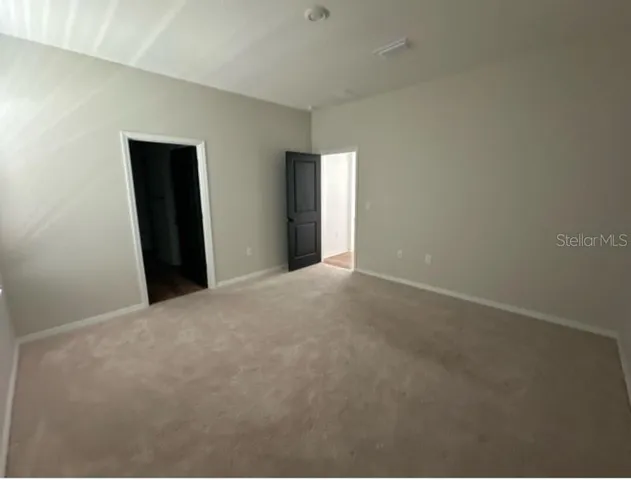 a view of an empty room with closet