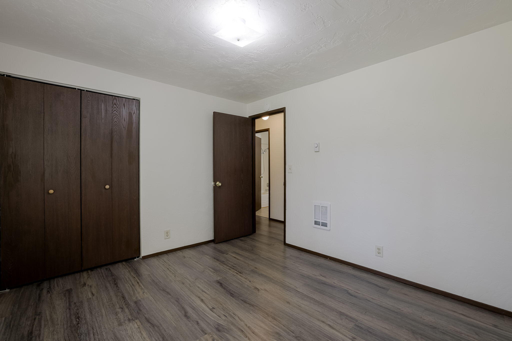 19968 Double Tree Court Bend, OR 97702 - Photo 16 of 28 a view of an empty room with wooden floor and closet