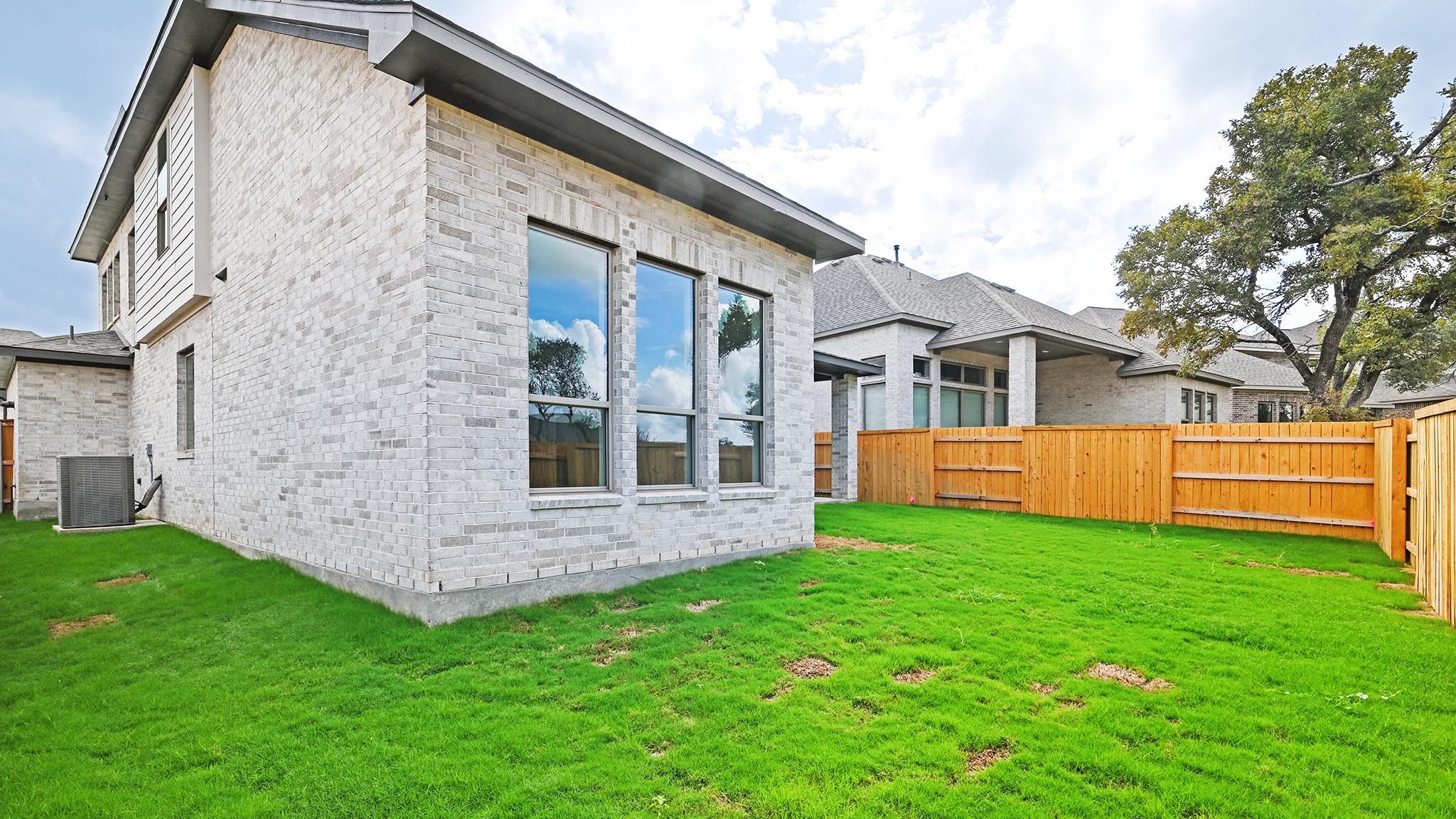 338 Prickly Poppy Loop Kyle, TX 78640 - Photo 24 of 40 Rear view of house with a fenced backyard and brick siding
