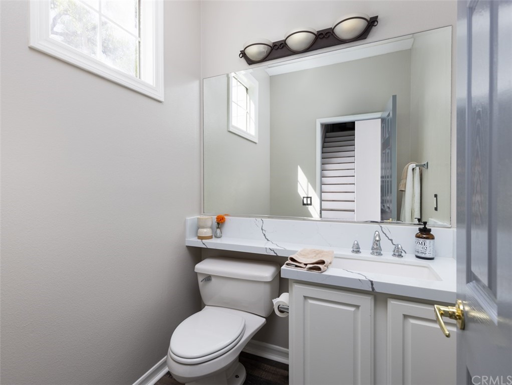 9 Thorp Ladera Ranch Ladera Ranch, CA 92694 - Photo 12 of 34 a bathroom with a granite countertop toilet sink and mirror