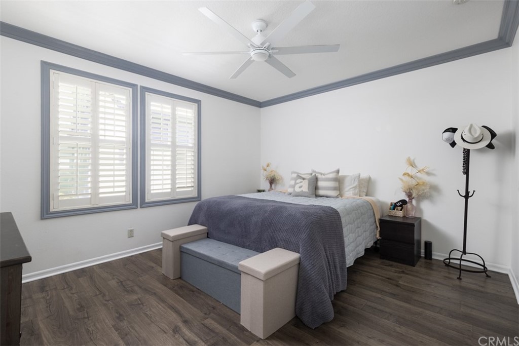 9 Thorp Ladera Ranch Ladera Ranch, CA 92694 - Photo 13 of 34 a spacious bedroom with a bed and a chandelier