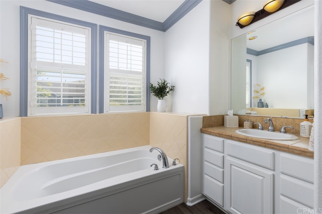 9 Thorp Ladera Ranch Ladera Ranch, CA 92694 - Photo 16 of 34 a bathroom with a granite countertop tub a sink and a window