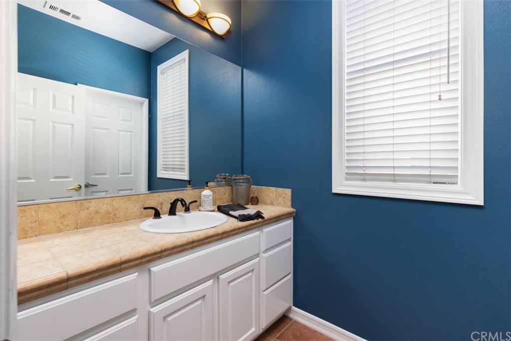 9 Thorp Ladera Ranch Ladera Ranch, CA 92694 - Photo 23 of 34 a bathroom with a granite countertop sink and a mirror