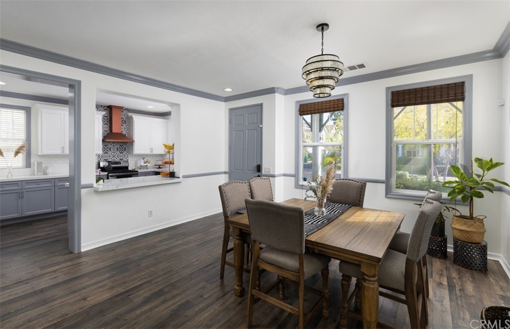 9 Thorp Ladera Ranch Ladera Ranch, CA 92694 - Photo 6 of 34 a dining room with wooden floor a chandelier a wooden table and chairs