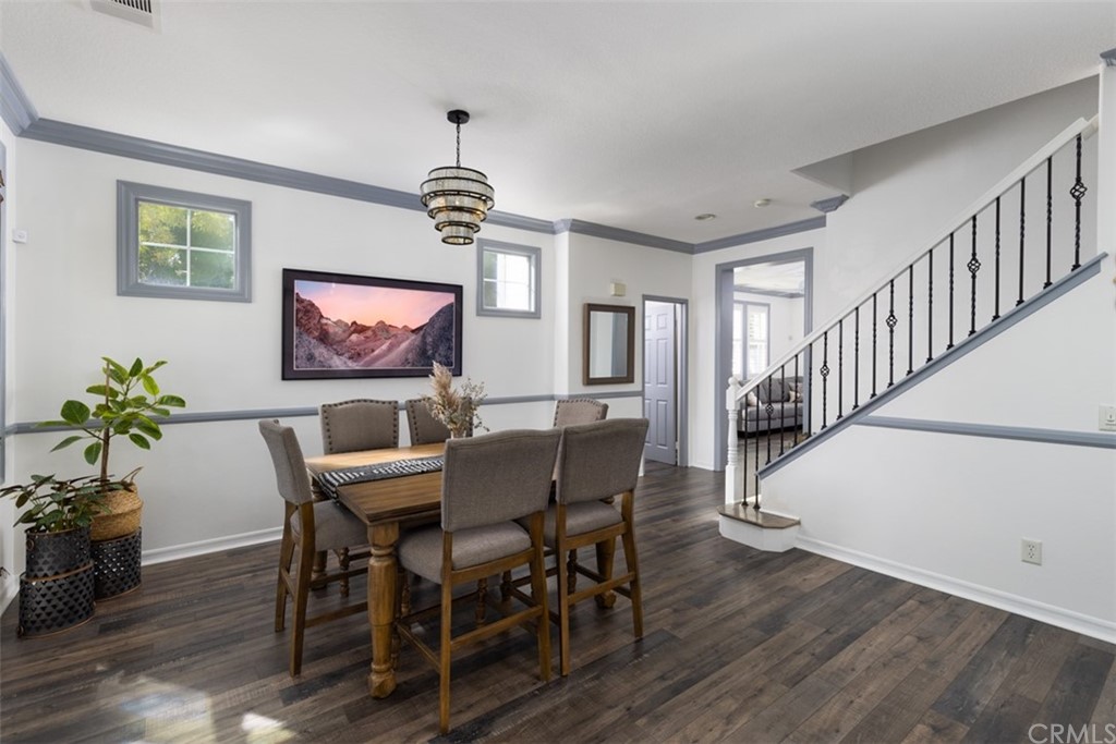 9 Thorp Ladera Ranch Ladera Ranch, CA 92694 - Photo 7 of 34 a dining room with wooden floor a chandelier a wooden table and chairs