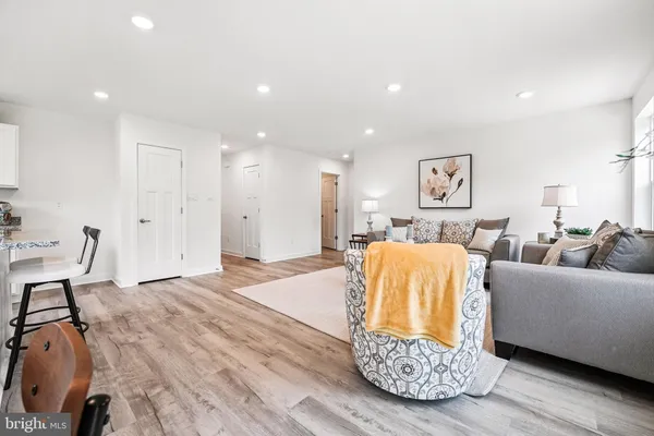 a kitchen with stainless steel appliances granite countertop a sink a stove a dining table and chairs