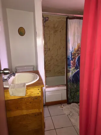 a bathroom with a bathtub and a shower