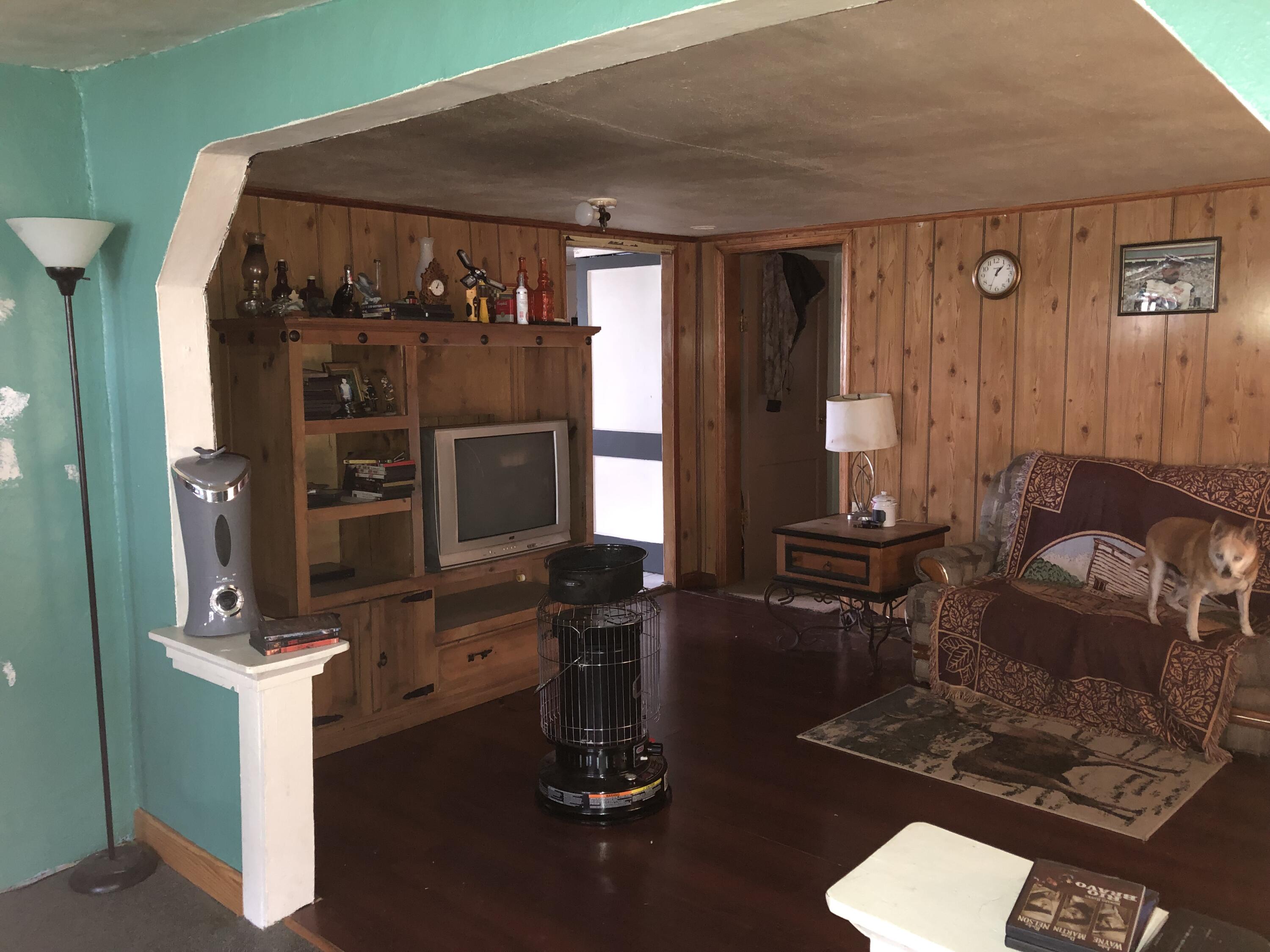 400 12th Street Selma, VA 24474 - Photo 8 of 16 a living room with furniture a flat screen tv and gym equipment