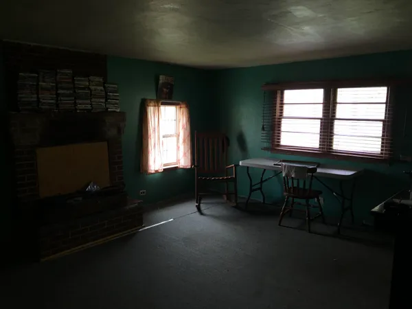 a living room with furniture and a two windows