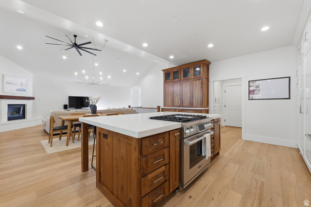 441 South 2080th Street East Springville, UT 84663 - Photo 17 of 64 Kitchen island with integrated stainless steel range, light wood-finish flooring, white countertops, built-in cabinetry, and recessed lighting