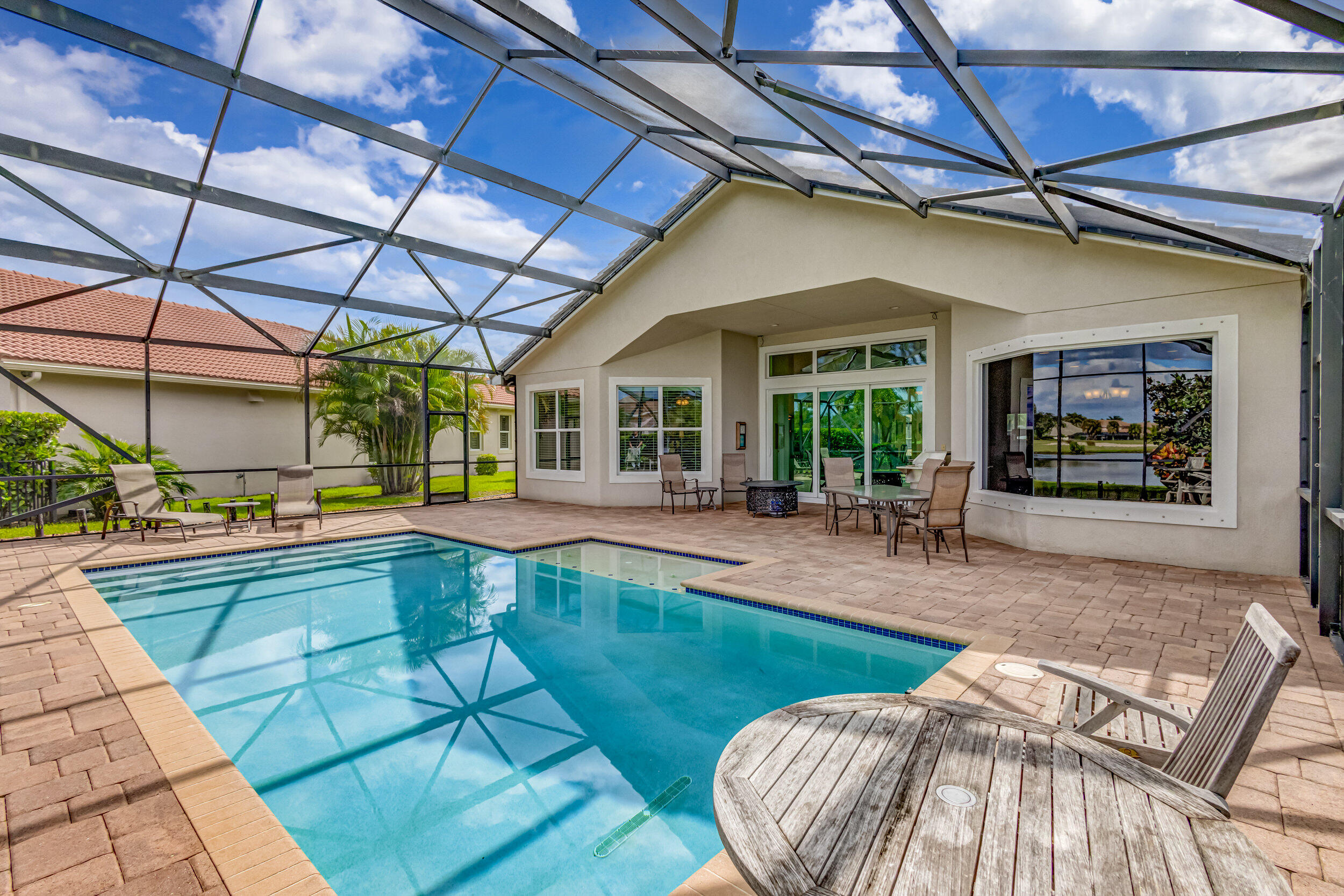 237 Carina Drive Jupiter, FL 33478 - Photo 16 of 73 a view of a swimming pool with a patio