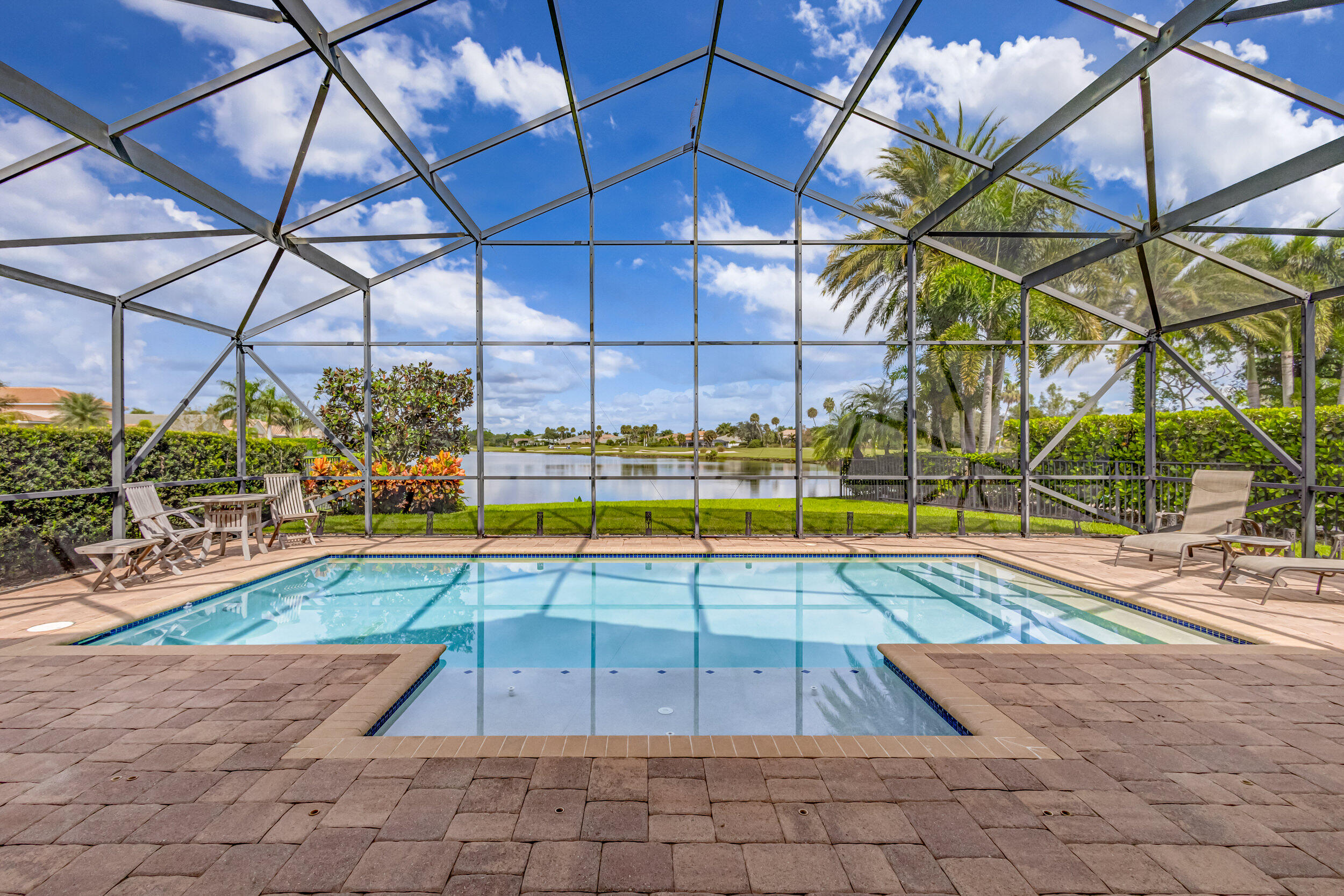 237 Carina Drive Jupiter, FL 33478 - Photo 21 of 73 a view of a swimming pool with a patio