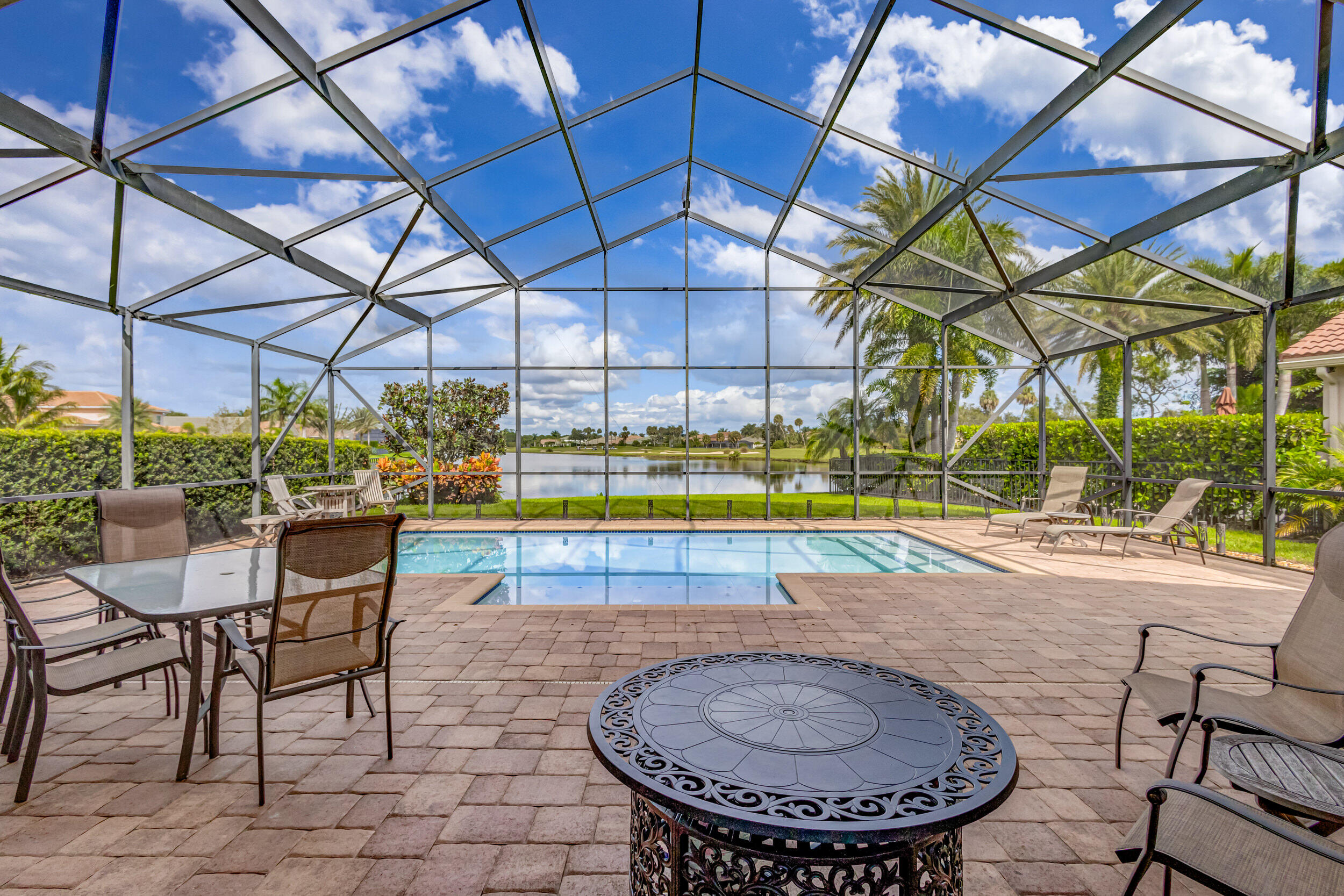 237 Carina Drive Jupiter, FL 33478 - Photo 22 of 73 a view of a swimming pool with a patio
