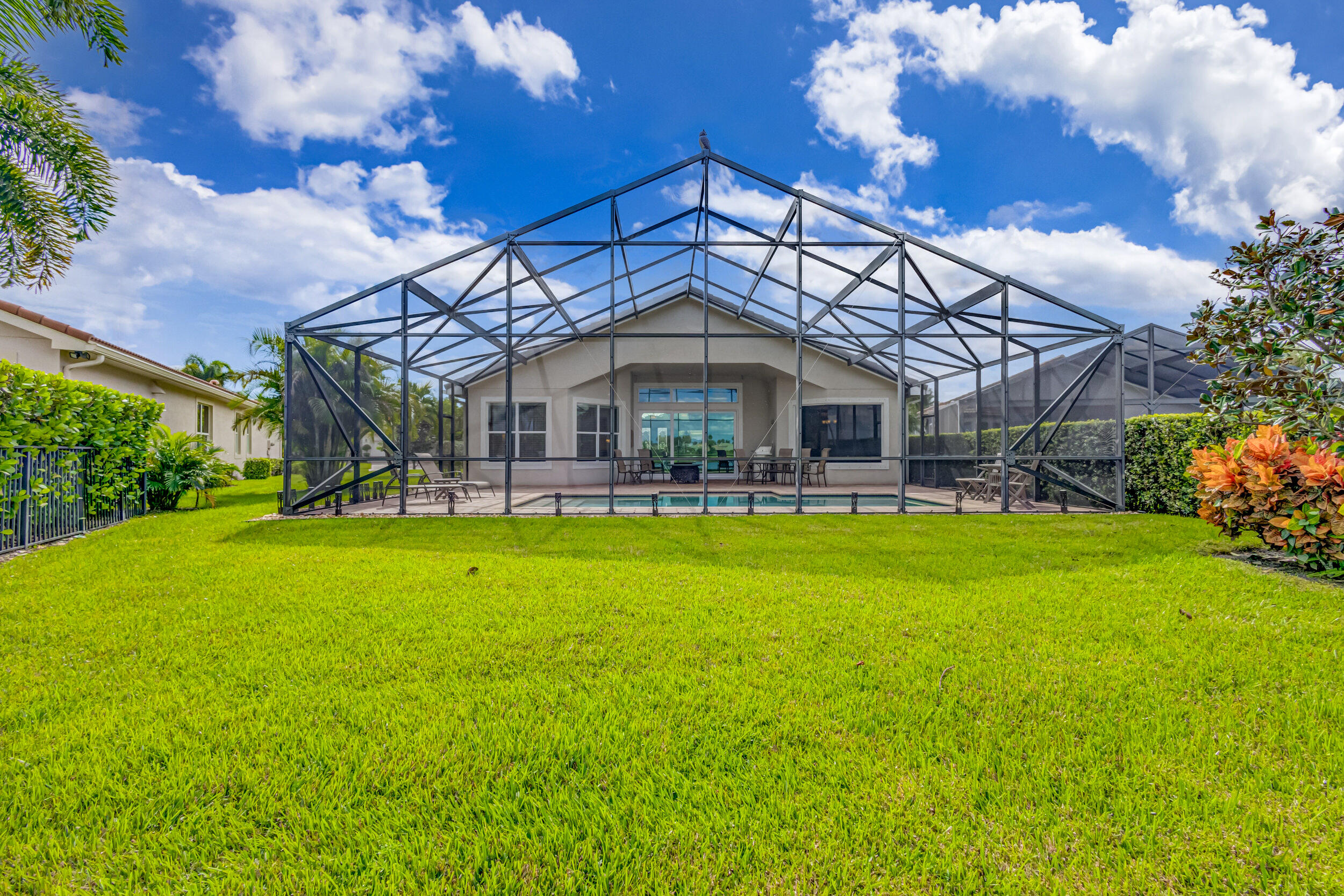 237 Carina Drive Jupiter, FL 33478 - Photo 23 of 73 a patio with a yard table and chairs