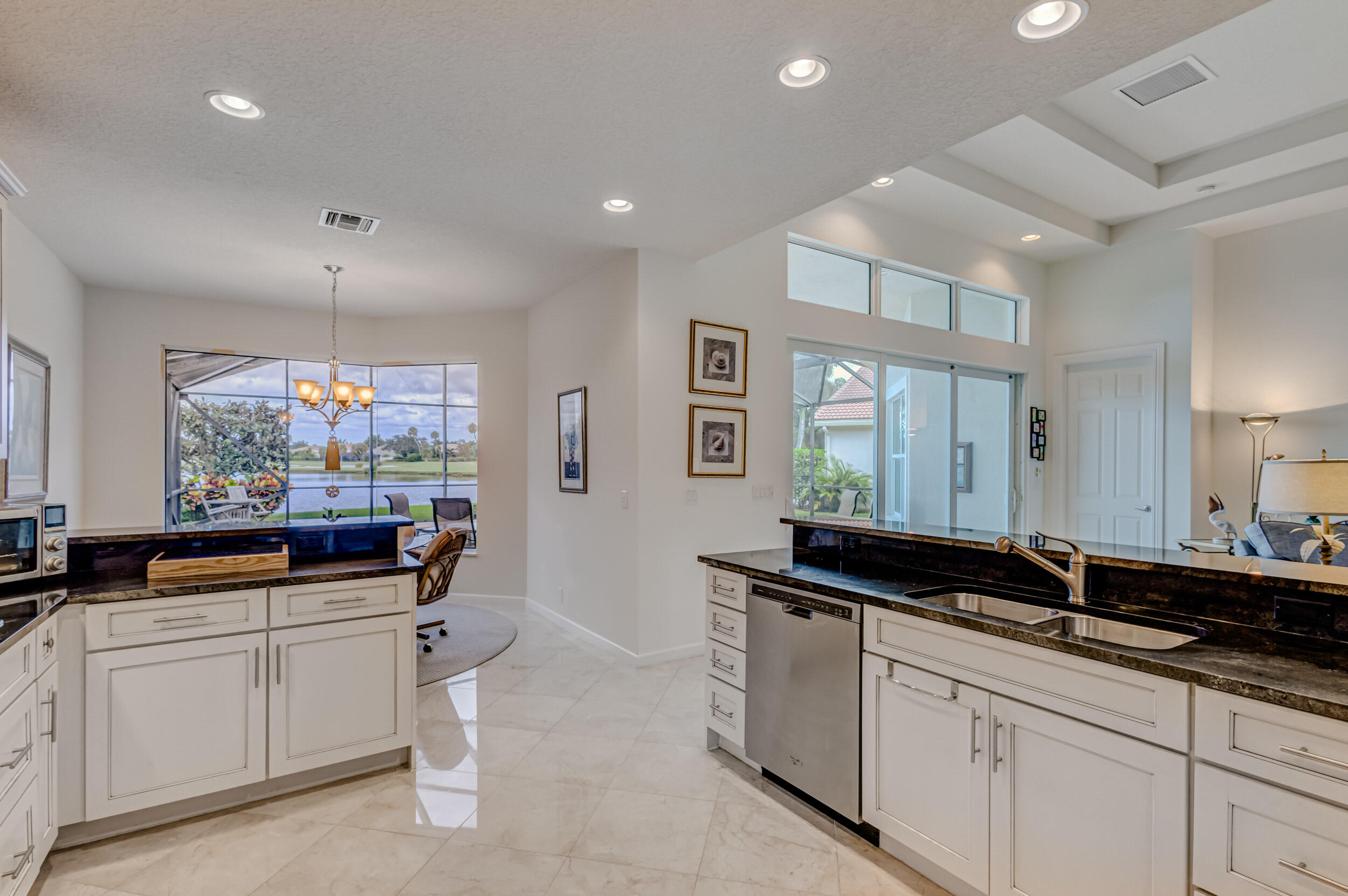 237 Carina Drive Jupiter, FL 33478 - Photo 29 of 73 a kitchen with granite countertop a sink and cabinets