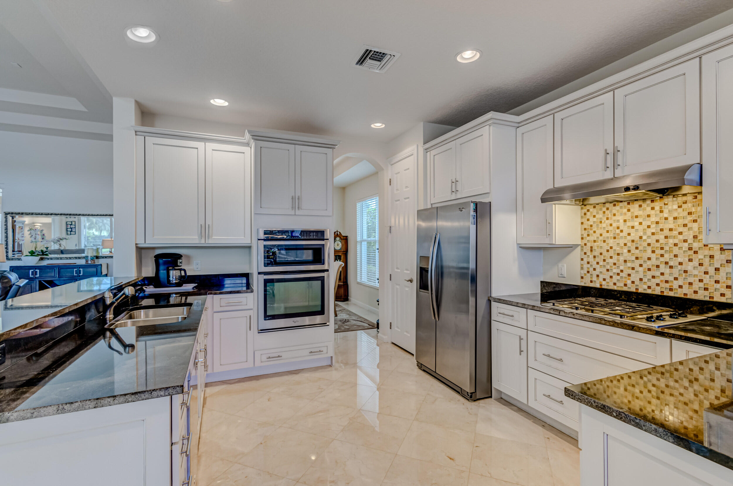237 Carina Drive Jupiter, FL 33478 - Photo 34 of 73 a kitchen with refrigerator and cabinets