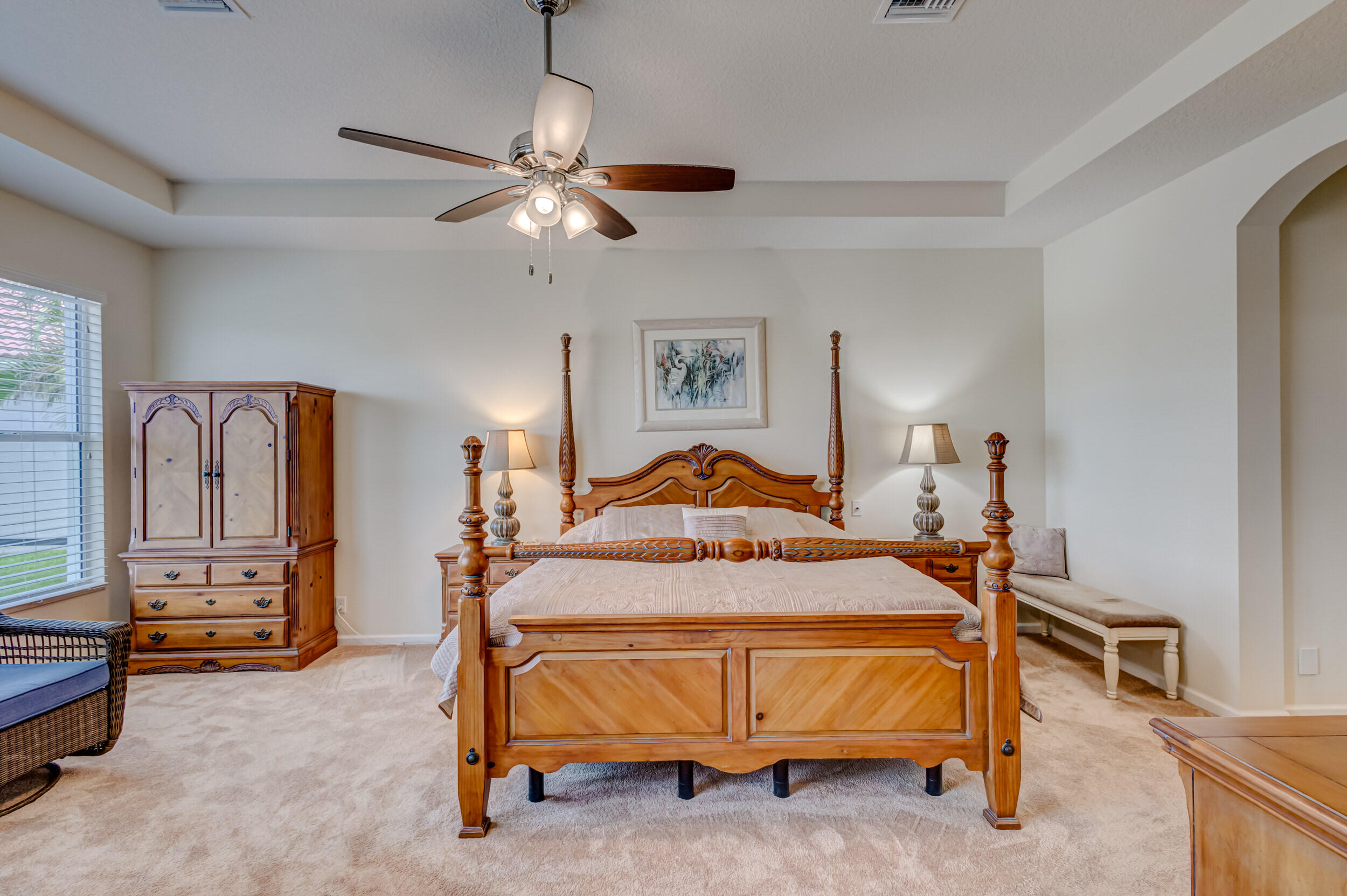 237 Carina Drive Jupiter, FL 33478 - Photo 36 of 73 a bedroom with a bed and a chandelier