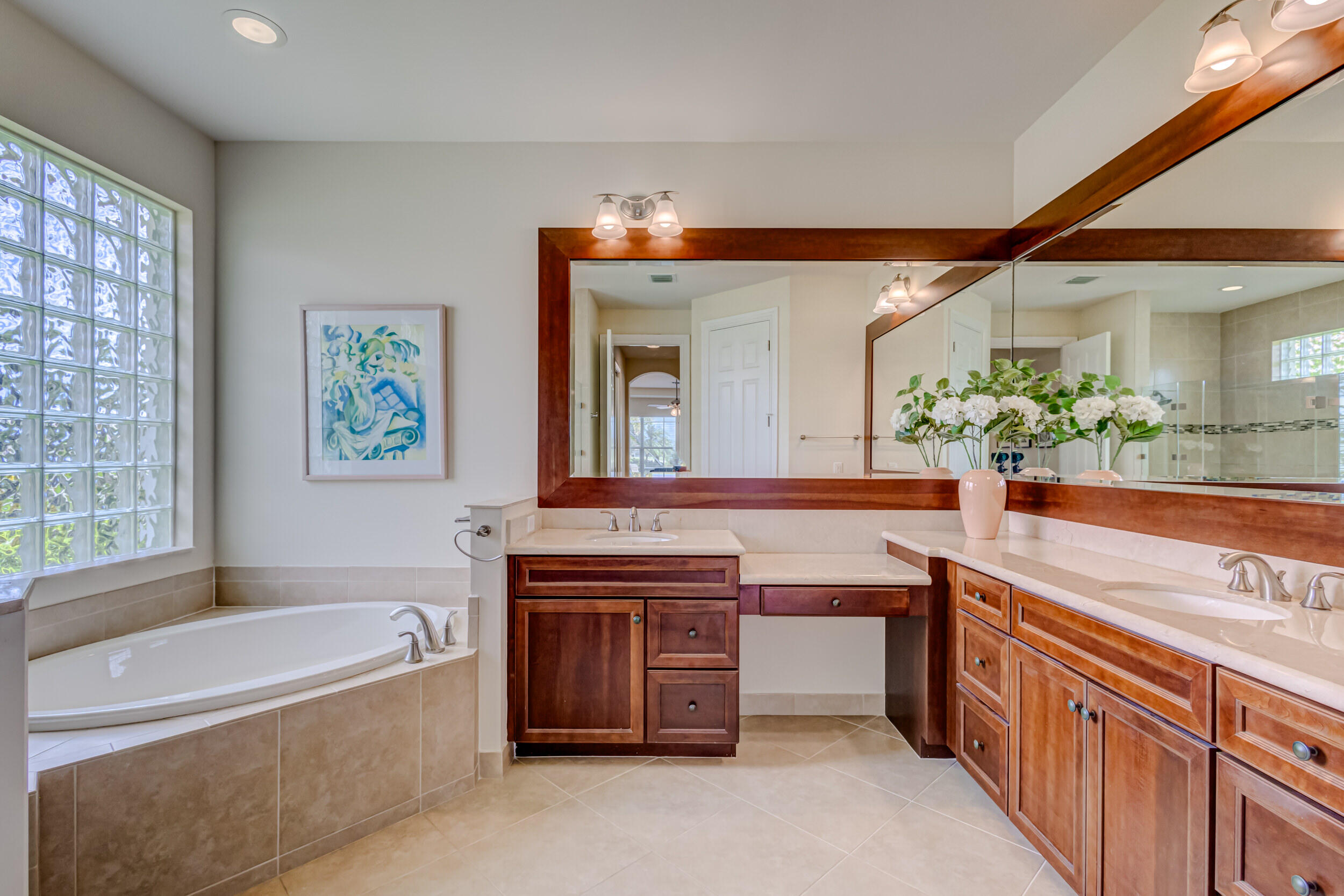 237 Carina Drive Jupiter, FL 33478 - Photo 40 of 73 a spacious bathroom with a tub a sink and a large mirror