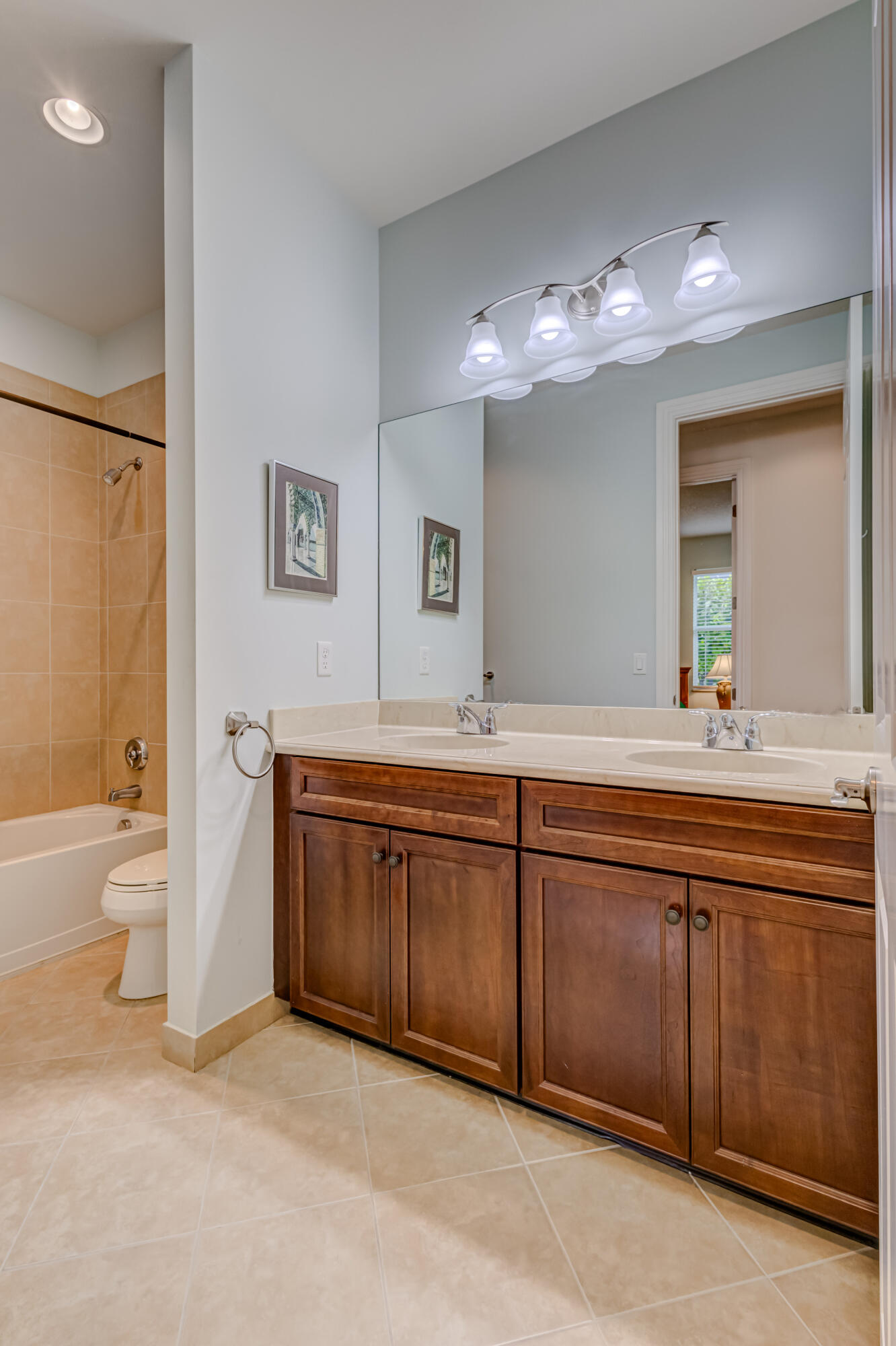 237 Carina Drive Jupiter, FL 33478 - Photo 47 of 73 a spacious bathroom with a granite countertop sink and a large mirror