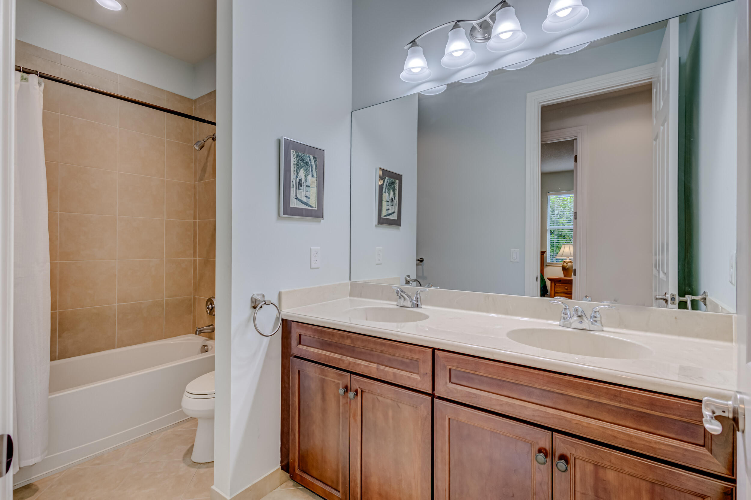 237 Carina Drive Jupiter, FL 33478 - Photo 50 of 73 a bathroom with a granite countertop sink a toilet and shower