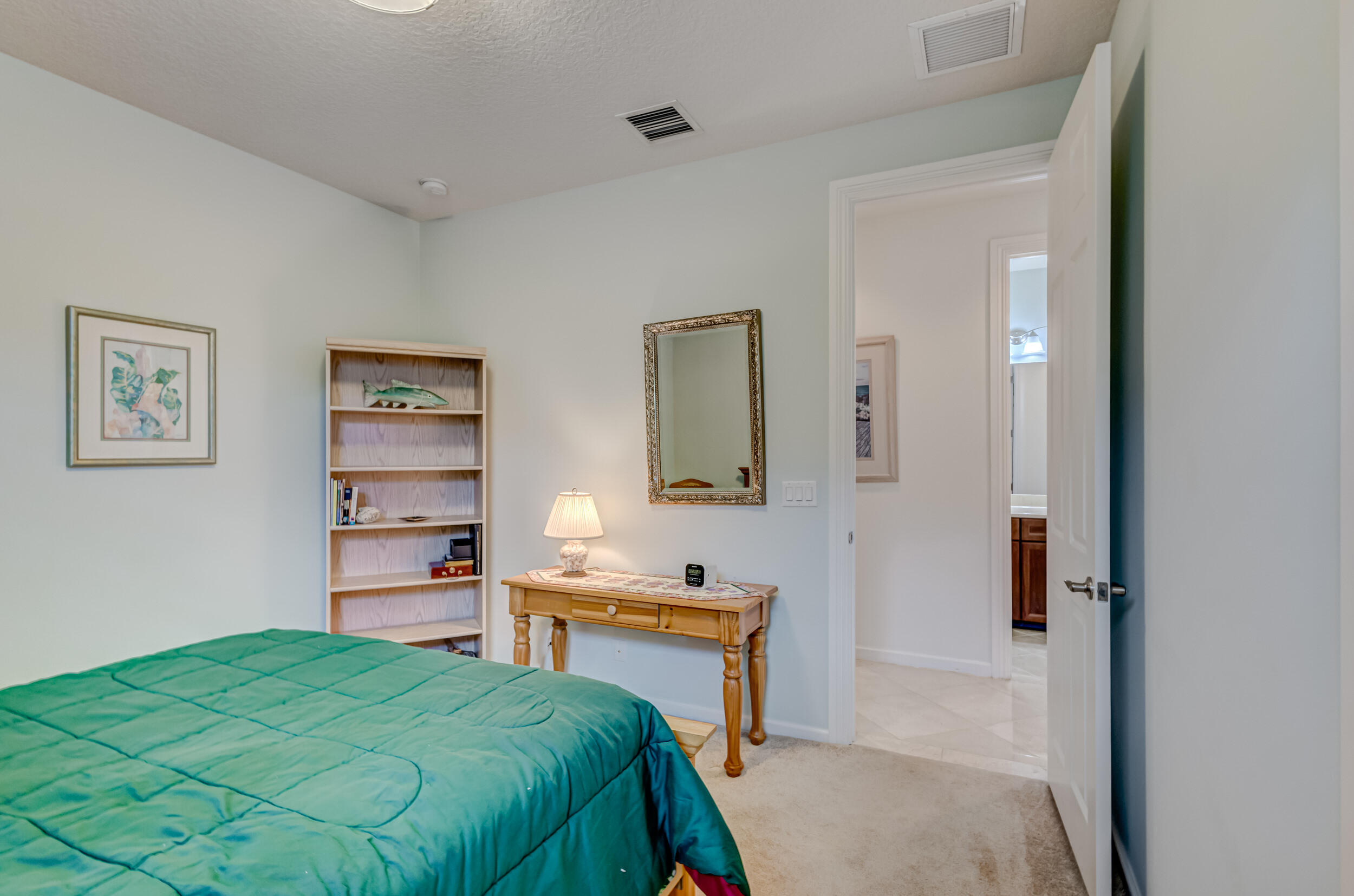 237 Carina Drive Jupiter, FL 33478 - Photo 51 of 73 a bedroom with a bed and a cabinets