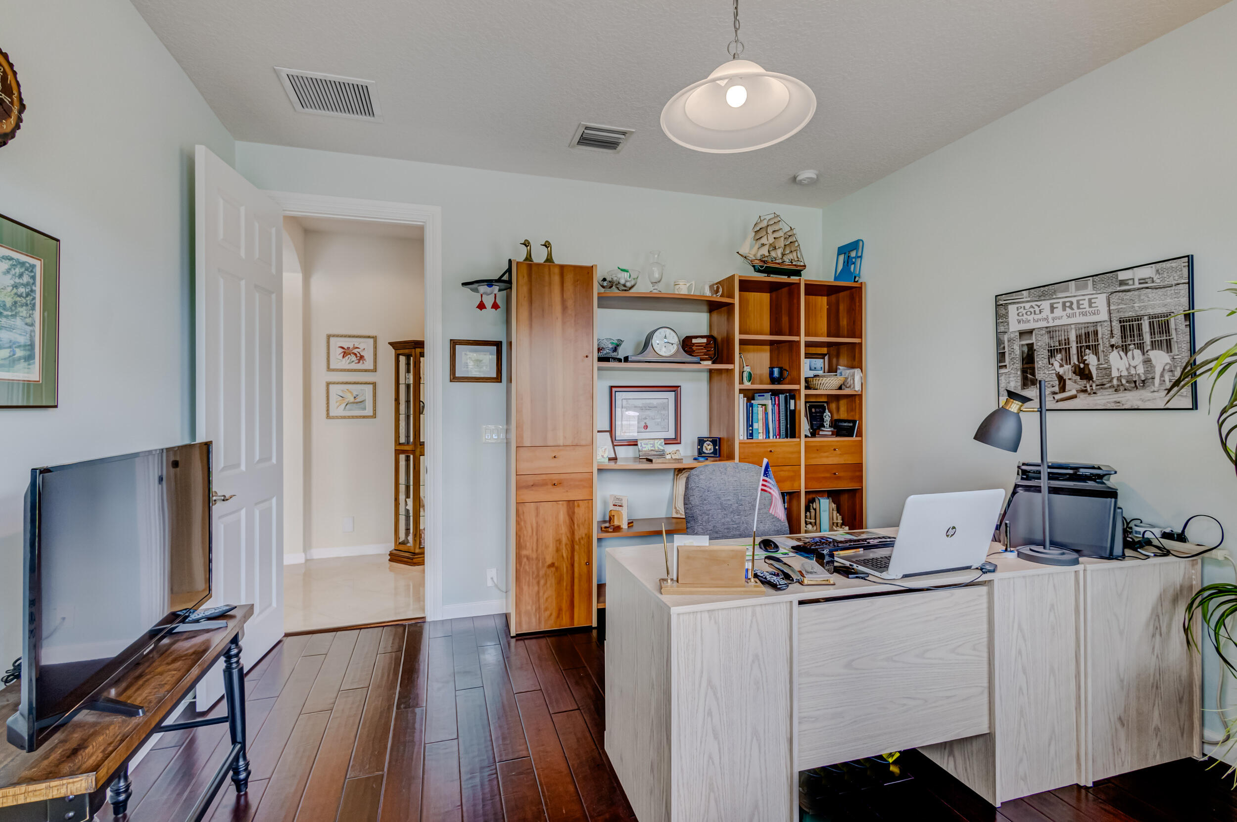 237 Carina Drive Jupiter, FL 33478 - Photo 56 of 73 a work room with furniture and a flat screen tv