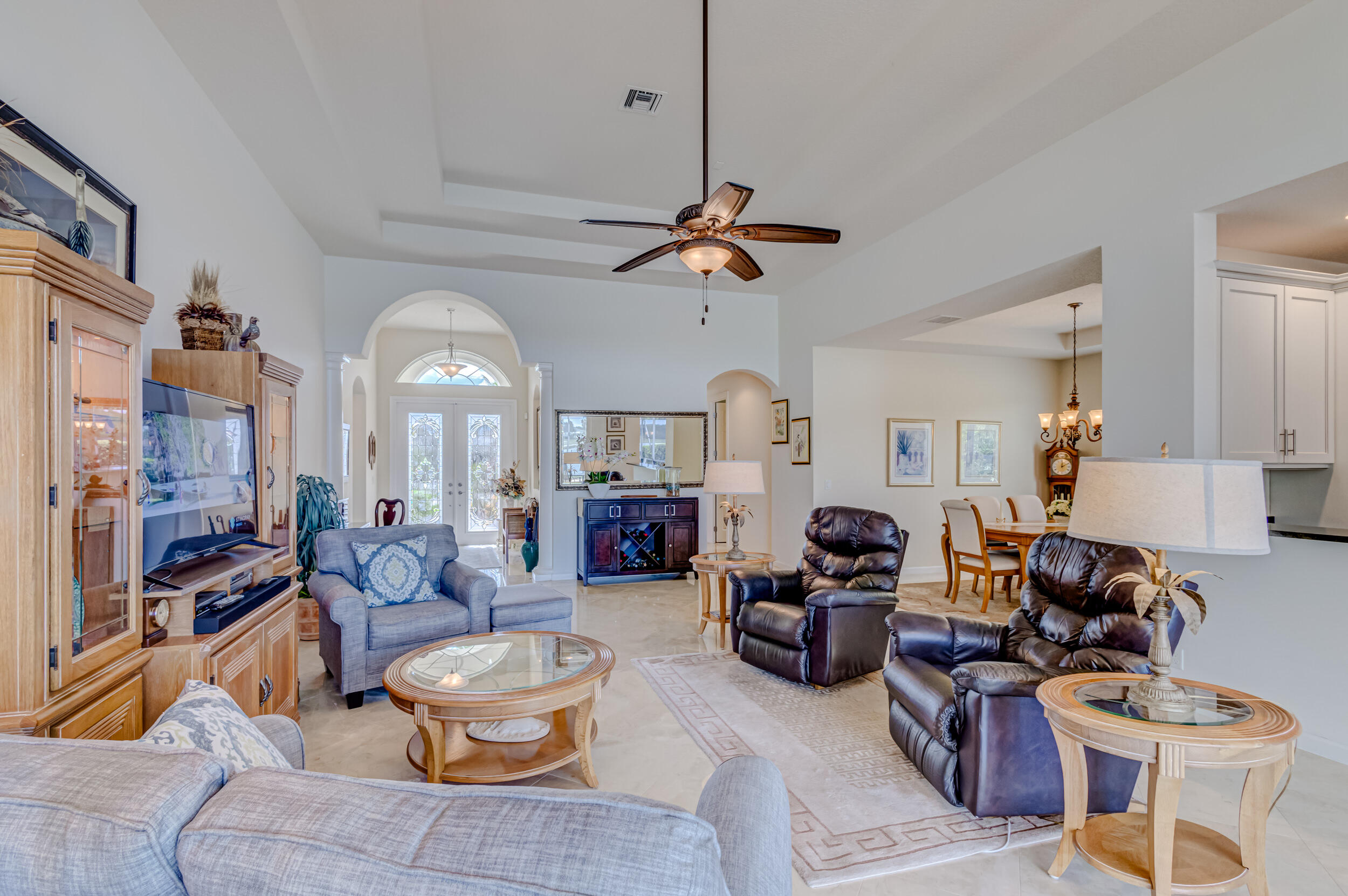237 Carina Drive Jupiter, FL 33478 - Photo 58 of 73 a living room with furniture a rug and a chandelier