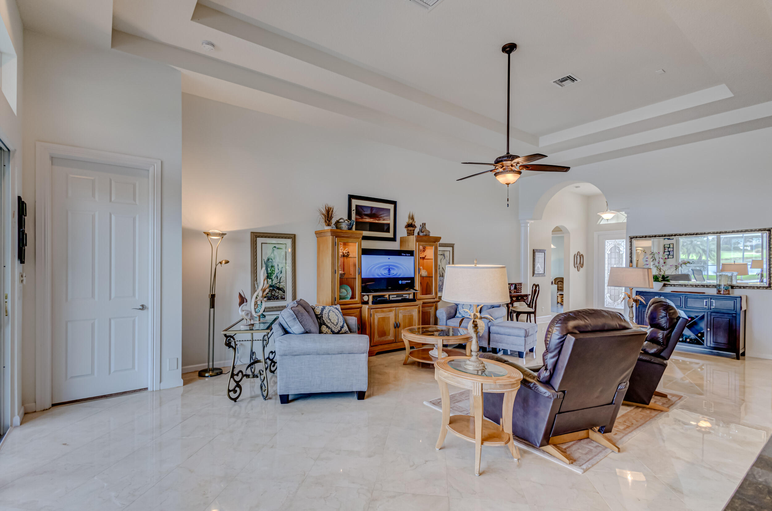 237 Carina Drive Jupiter, FL 33478 - Photo 61 of 73 a living room with furniture and a chandelier