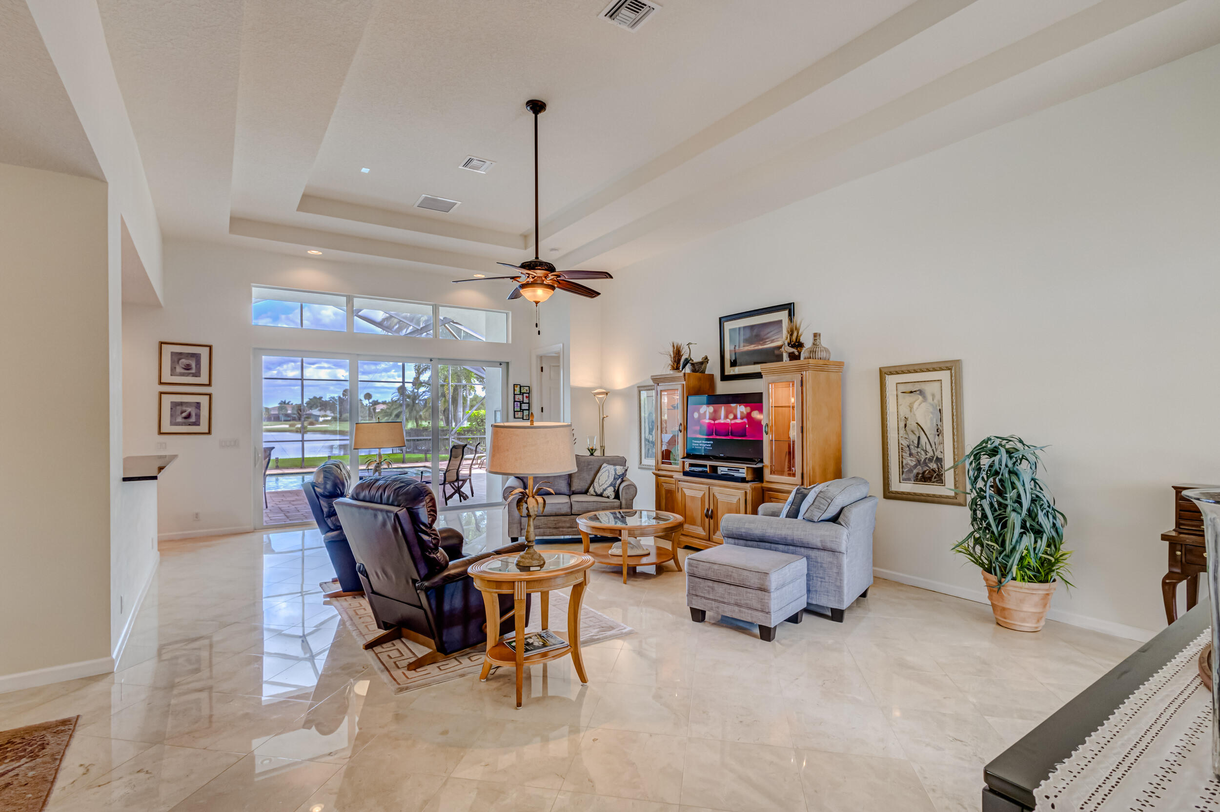 237 Carina Drive Jupiter, FL 33478 - Photo 65 of 73 a living room with furniture and a flat screen tv
