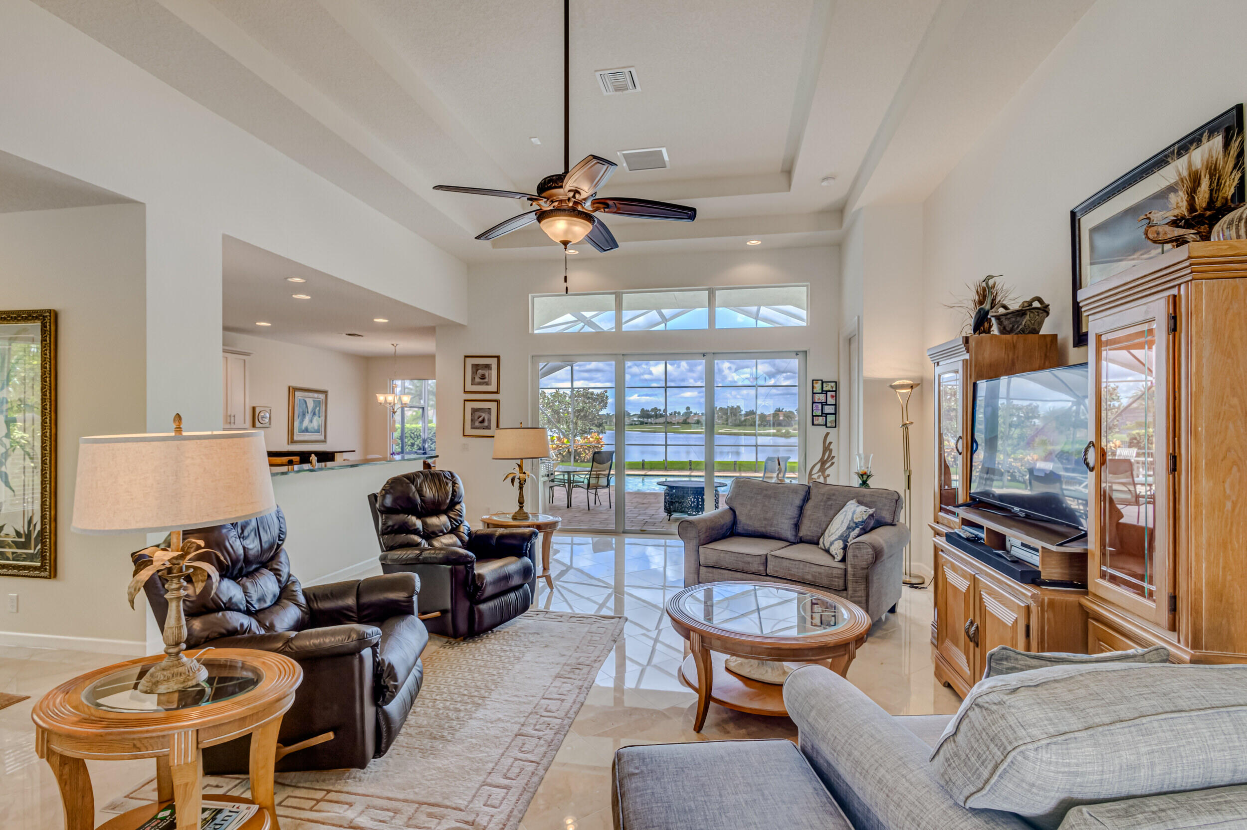 237 Carina Drive Jupiter, FL 33478 - Photo 66 of 73 a living room with furniture ceiling fan and a window