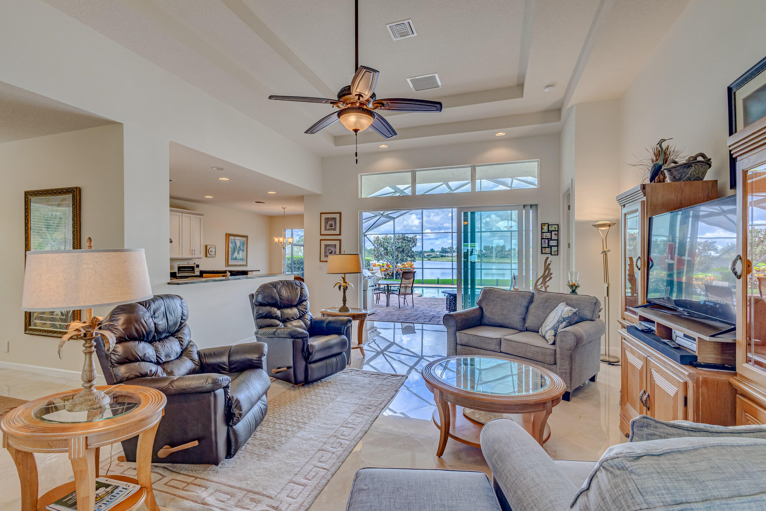 237 Carina Drive Jupiter, FL 33478 - Photo 67 of 73 a living room with furniture a ceiling fan and a window
