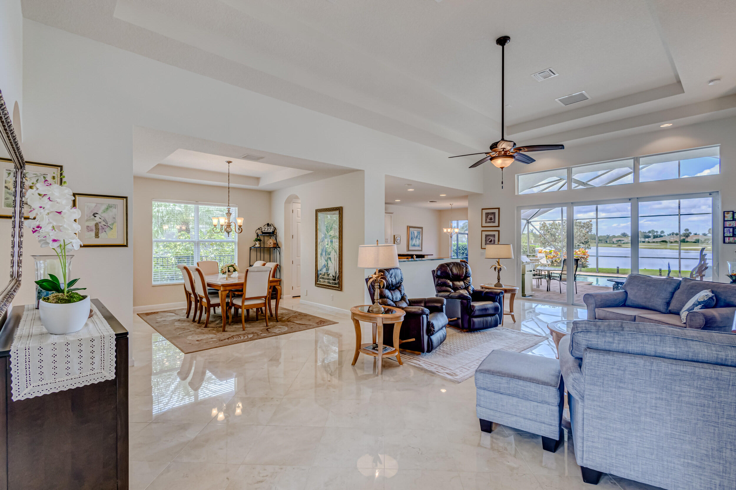 237 Carina Drive Jupiter, FL 33478 - Photo 68 of 73 a living room with furniture and a floor to ceiling window