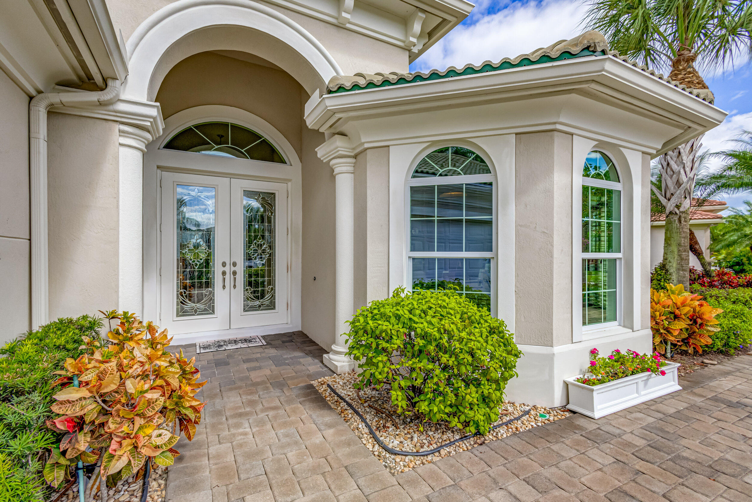 237 Carina Drive Jupiter, FL 33478 - Photo 10 of 73 a front view of a house with garden