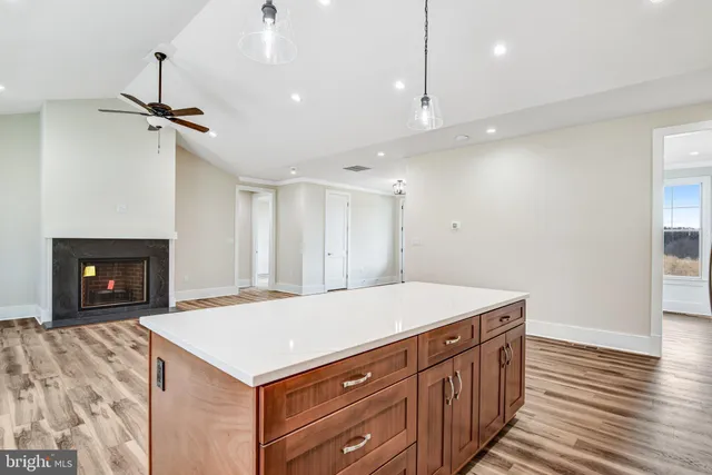 a view of an empty room with window and fire place