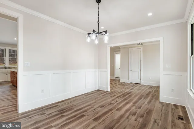 a view of a room with wooden floor closet and windows