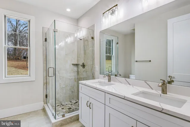 a view of a bedroom with wooden floor
